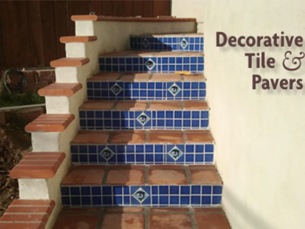 Exterior stairway finished in terracotta paver treads with hand-painted blue decorative tile risers.
